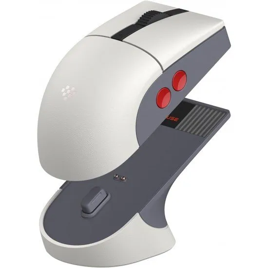 A retro-styled gaming mouse in grey and red tones sitting on a matching magnetic charging dock with a small signal extension light