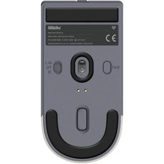 A retro-styled gaming mouse in grey and red tones sitting on a matching magnetic charging dock with a small signal extension light
