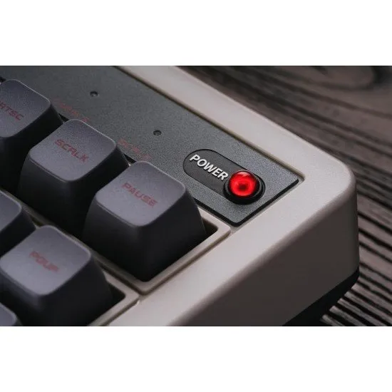 A vintage-style mechanical keyboard with grey and off-white keycaps, red accents, and two oversized external arcade buttons