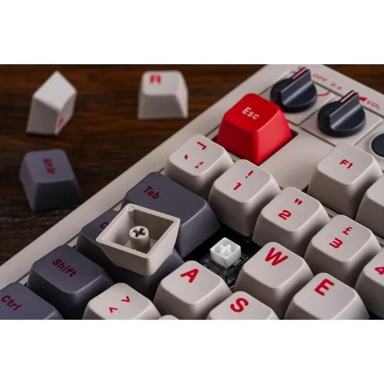 A vintage-style mechanical keyboard with grey and off-white keycaps, red accents, and two oversized external arcade buttons