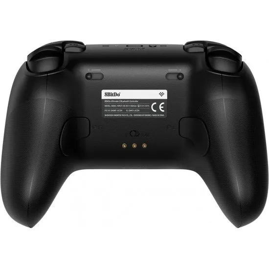 A premium black wireless controller with an RGB ring around the joysticks, sitting on a matching black charging dock