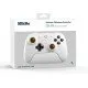 A sleek white pro-style controller with offset sticks and back paddles sitting in a matching white magnetic charging dock