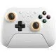 A sleek white pro-style controller with offset sticks and back paddles sitting in a matching white magnetic charging dock