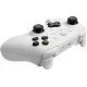 A sleek white pro-style controller with offset sticks and back paddles sitting in a matching white magnetic charging dock