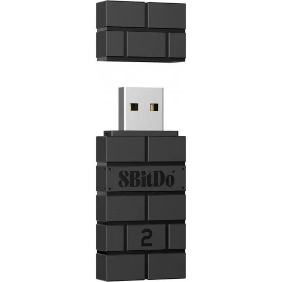 A small black USB adapter shaped like a classic brick with the 8BitDo logo and a pairing button