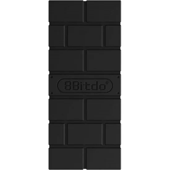 A small black USB adapter shaped like a classic brick with the 8BitDo logo and a pairing button