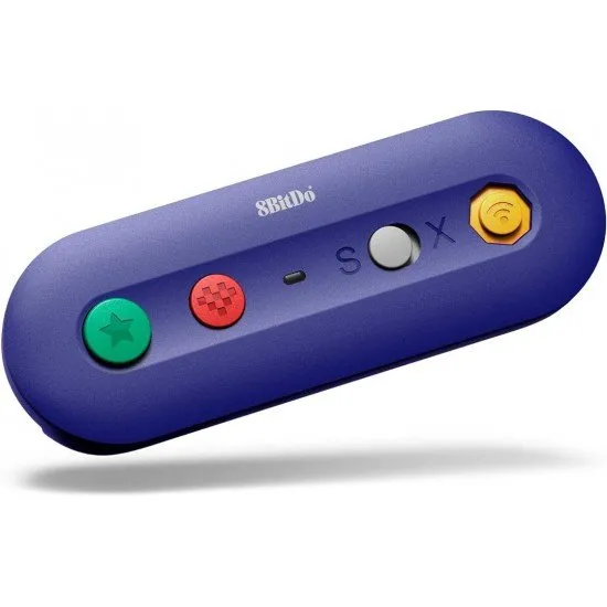 A small purple wireless adapter with ports for GameCube and Wii Classic controllers next to a Nintendo Switch console