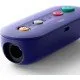 A small purple wireless adapter with ports for GameCube and Wii Classic controllers next to a Nintendo Switch console