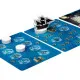 The box art of Adamastor board game showing a historical Portuguese caravel navigating through massive stormy waves under a dark brooding sky