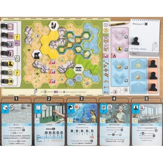 A board game expansion box showing a large aquarium tank with various colourful fish and marine life inside a modern zoo setting