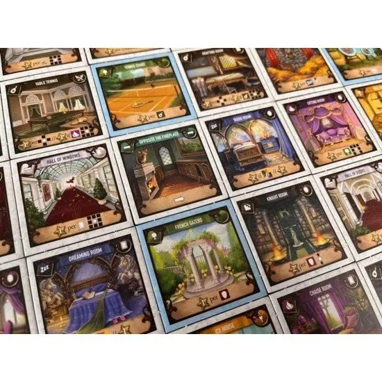 Between Two Castles Essential Edition board game box showing intricate castle blueprints and character portraits