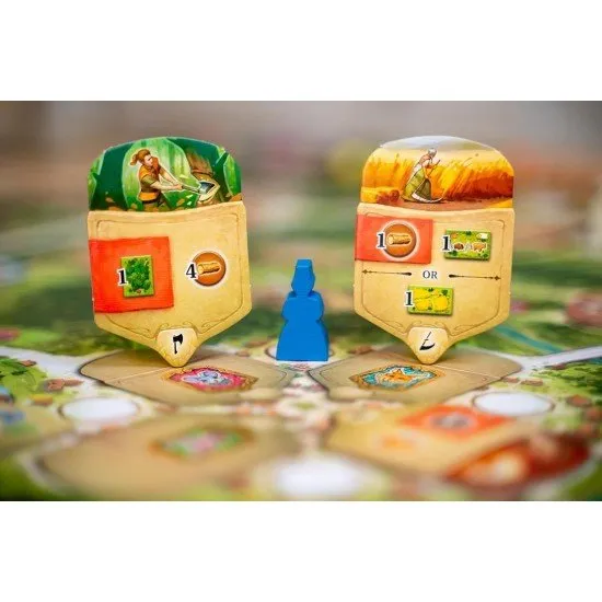 Black Forest board game box art showing a traditional German village and resource management components