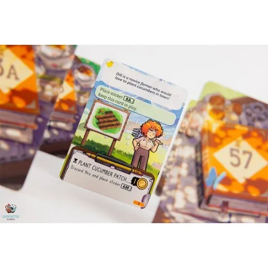 Cozy Stickerville board game box showing a vibrant village landscape and various colourful stickers