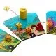 The box art for the Dandelions board game, showing dice and seeds floating over a garden landscape.