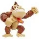 A highly detailed plastic action figure of Donkey Kong smiling and flexing his muscles inside a red and white Nintendo-themed window box packaging