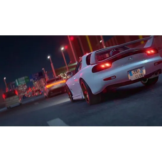 A customised Nissan sports car racing at high speed through a neon-lit Japanese city street
