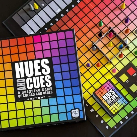 The box art for the Hues and Cues board game, featuring a colorful grid of hues with game pieces on it.
