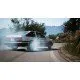 A PlayStation 5 game case showing a highly modified Japanese sports car drifting sideways around a sharp mountain hairpin bend surrounded by pink cherry blossom trees