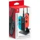 Official Nintendo Switch packaging showing a black two-way charging stand holding a blue and red Joy-Con controller with a power cable attached