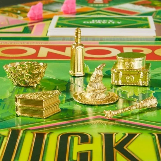 The box art for the Monopoly Wicked Edition board game, featuring characters from the film and custom golden game tokens.