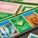 The box art for the Monopoly Wicked Edition board game, featuring characters from the film and custom golden game tokens.