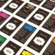 The box art for the Monopoly: Willy Wonka & the Chocolate Factory board game, featuring Gene Wilder as Willy Wonka and the game's unique tokens.