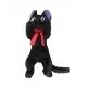 Jiji the black cat plush in a relaxed laying position with a red bow and soft fabric finish