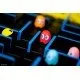 The box art for the Quoridor: PAC-MAN board game, showing wooden pawns of PAC-MAN and the ghosts on a wooden maze board.