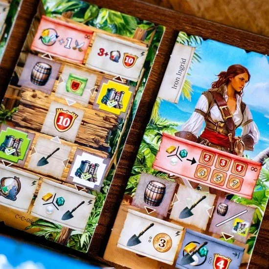 The box art for the Pirates of Maracaibo board game, showing a pirate ship on the high seas with a map in the background.