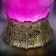 A d20-shaped glass bottle containing glowing purple liquid with a swirling mist effect sitting on a grey stone castle base