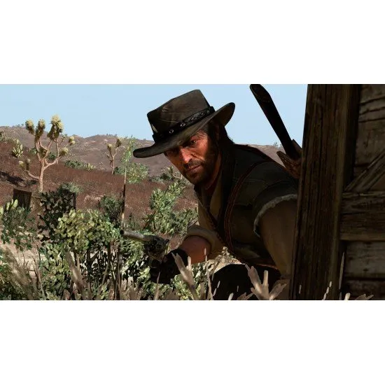A PlayStation 5 game case featuring John Marston holding a sawed-off shotgun against a stark red and black western backdrop
