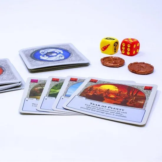 Two players sitting across from each other with personal card tableaus of settlements and roads