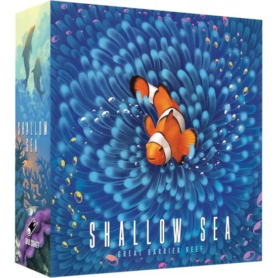 Colourful coral reef tiles and sea-life tokens arranged on a table to show a developing underwater habitat