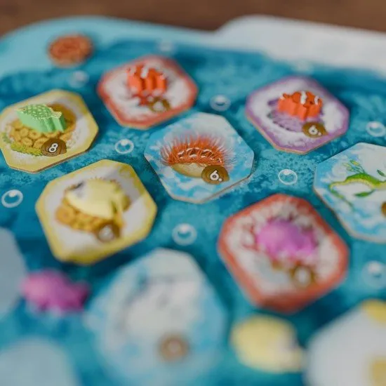 New turtle tokens and coral tiles from the Nesting Season expansion being added to the base game reef