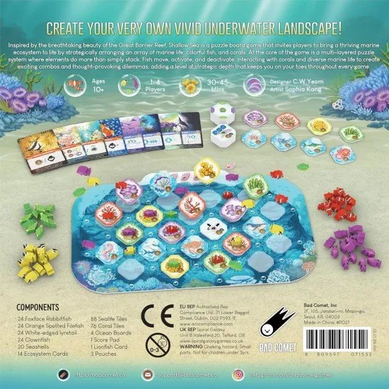 Colourful coral reef tiles and sea-life tokens arranged on a table to show a developing underwater habitat