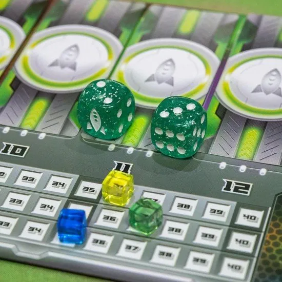 A colourful spread of space station cards with various sci-fi ship illustrations and dice