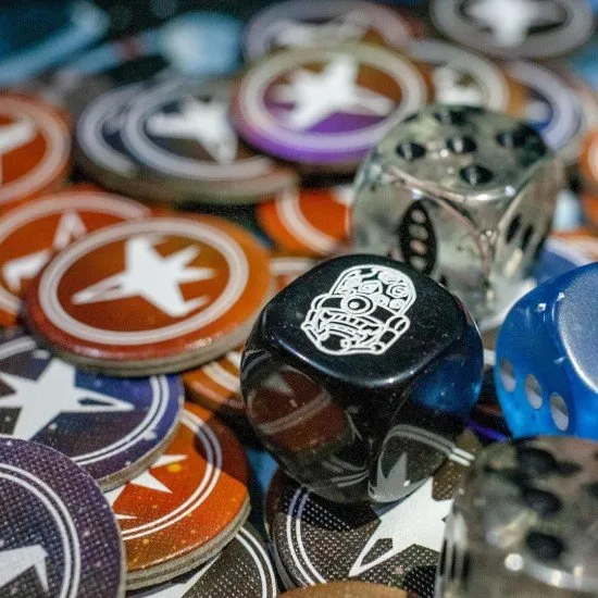 A colourful spread of space station cards with various sci-fi ship illustrations and dice