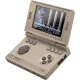 A handheld retro gaming console sporting the classic beige finish of the iconic 1980s computer displaying a bright pixel-art action screen