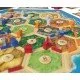 CATAN Traders & Barbarians 6th Edition box art showing new game components, merchant caravans, and barbarians threatening settlements