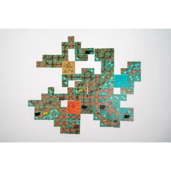 A portable set of trail cards showing winding paths and colourful campsites on a table