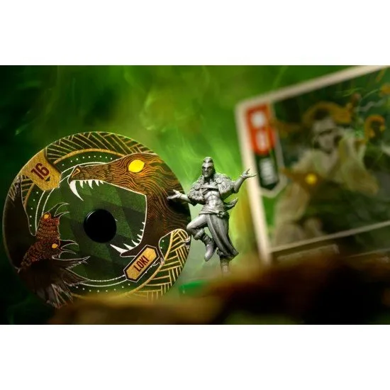 Four highly detailed character miniatures standing on a stylised circular battlefield board with vibrant card art in the background