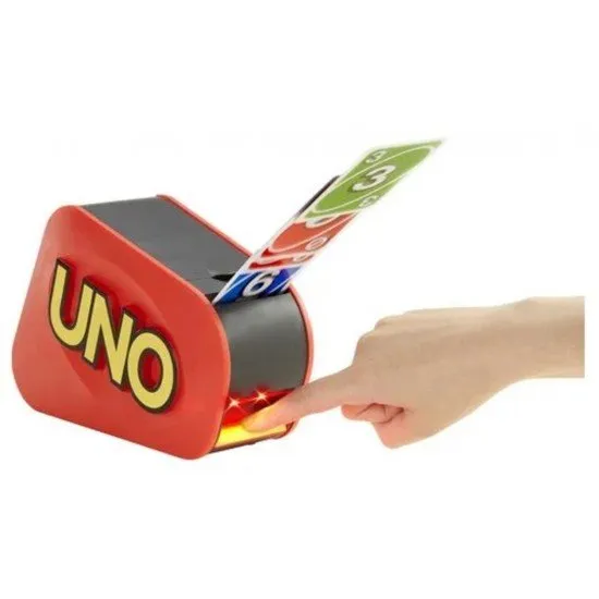 A group of friends laughing as the UNO Extreme launcher shoots several cards into the air