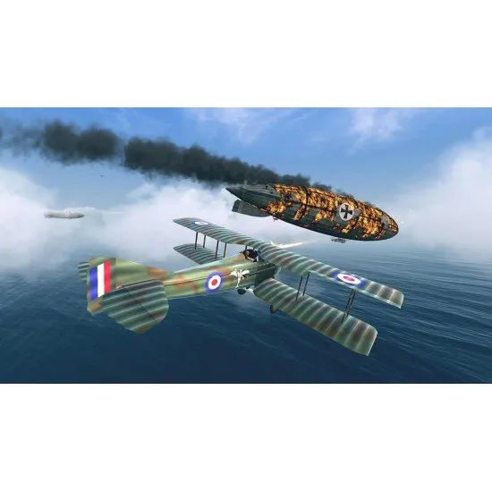 A classic biplane and a sleek WWII fighter flying through clouds over a rural landscape