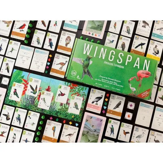 Colourful bird cards featuring a Bee Hummingbird and a Snowy Albatross on a vibrant game mat