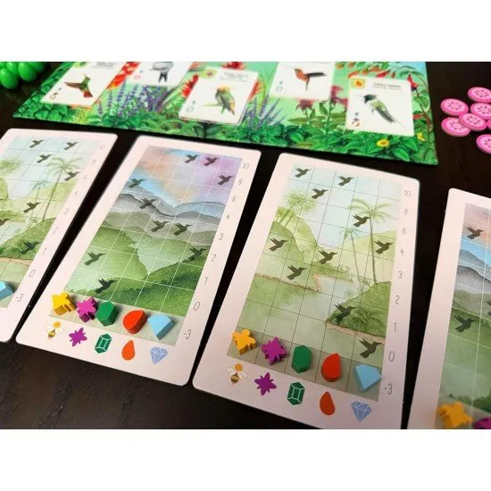 Colourful bird cards featuring a Bee Hummingbird and a Snowy Albatross on a vibrant game mat