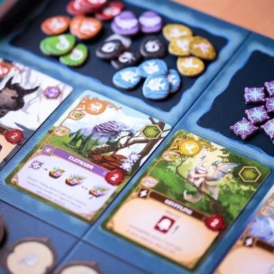 Wondrous Creatures board game box showing fantasy artwork, hexagonal puzzle board, and creature cards